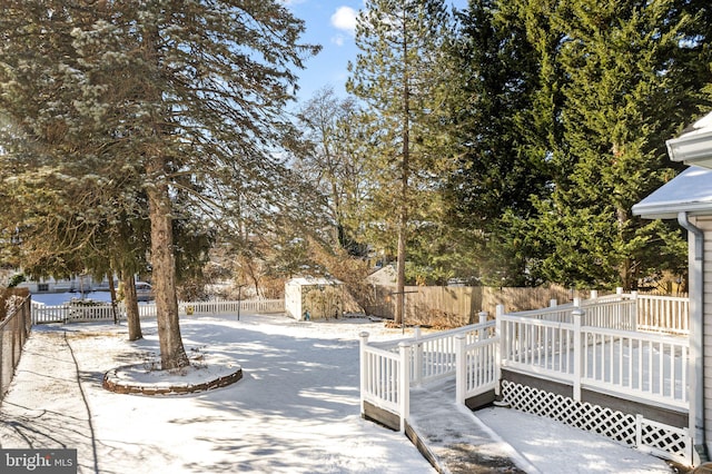 exterior space with a deck and a storage shed