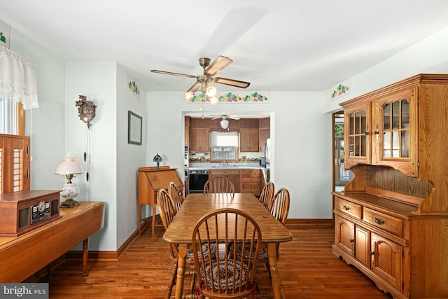 dining space with ceiling fan, dark wood-type flooring, and sink