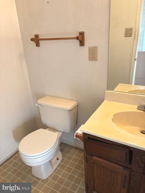 bathroom featuring toilet and vanity