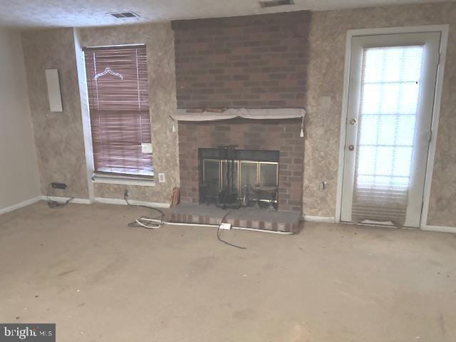 unfurnished living room featuring a brick fireplace