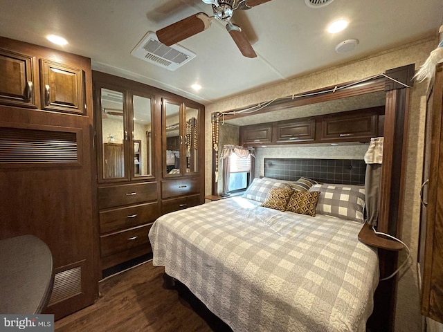 bedroom with ceiling fan and dark hardwood / wood-style floors