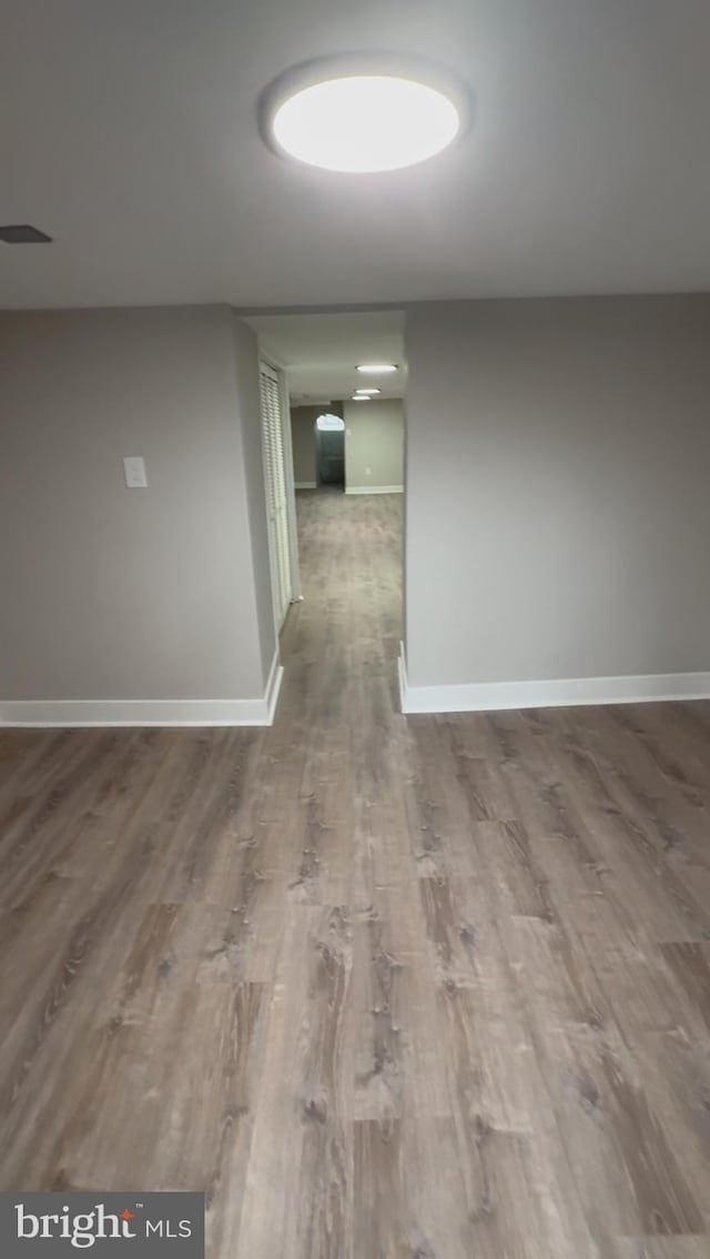 corridor featuring hardwood / wood-style floors