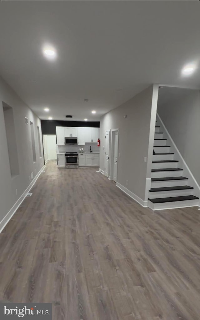 unfurnished living room with wood-type flooring