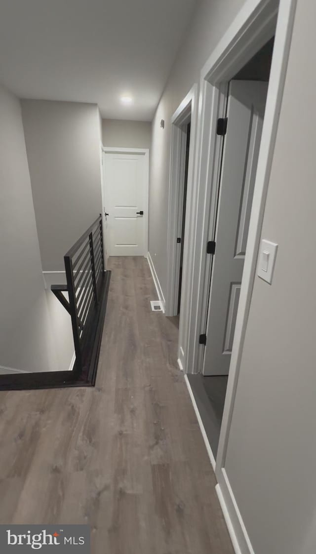 corridor featuring dark hardwood / wood-style floors