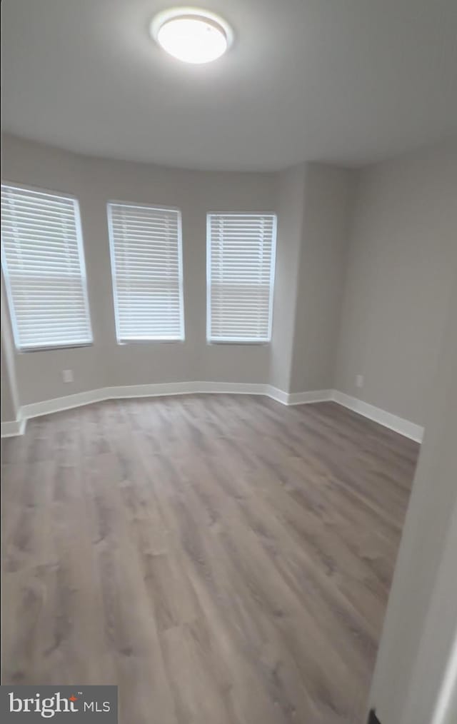 spare room with hardwood / wood-style flooring