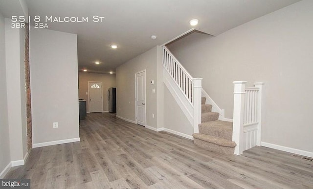 staircase featuring hardwood / wood-style flooring