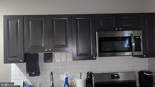 kitchen with electric range oven and tasteful backsplash