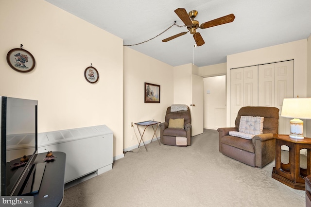 living area featuring ceiling fan and carpet floors