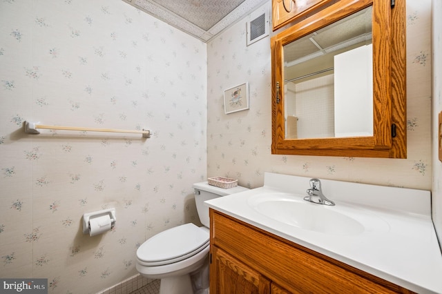 bathroom featuring toilet and vanity