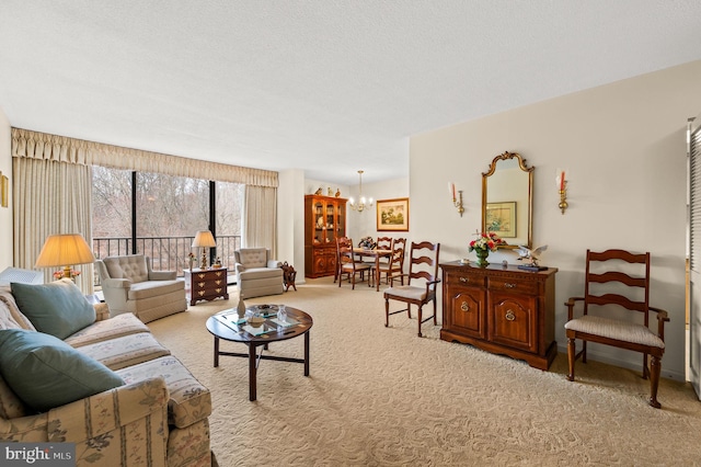 living room with a textured ceiling, an inviting chandelier, and light colored carpet