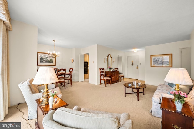 living room featuring an inviting chandelier and light colored carpet