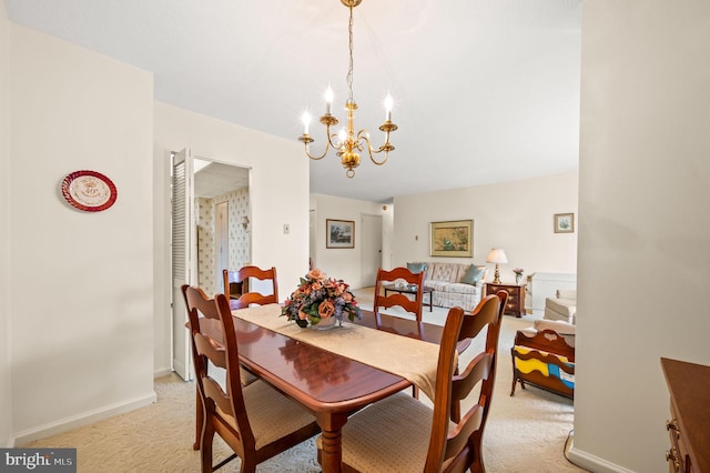 dining space with light carpet and a notable chandelier