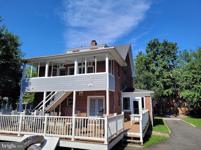 view of front of home with a wooden deck and french doors