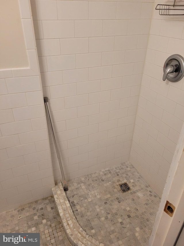 bathroom with a tile shower