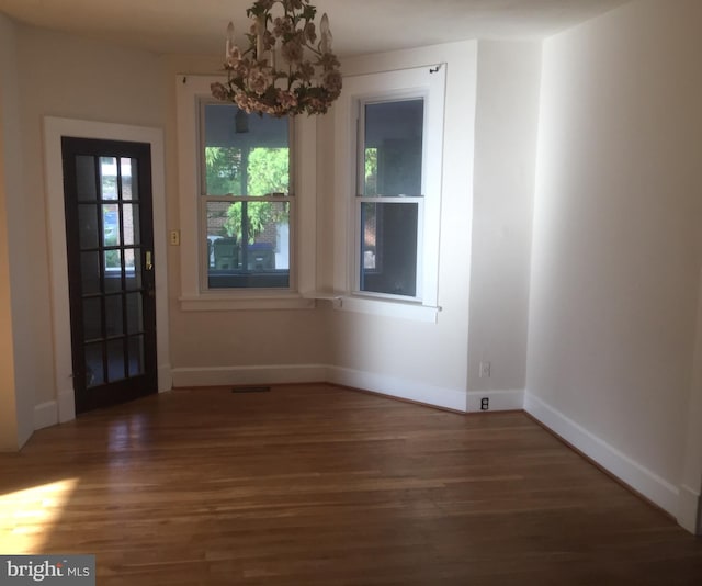 unfurnished dining area featuring dark wood-type flooring