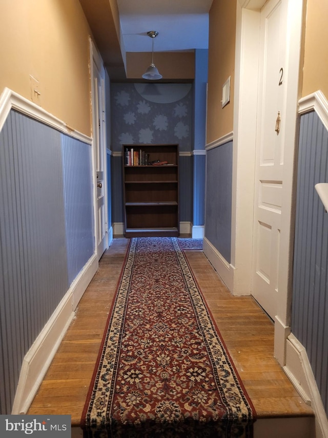 corridor with wood-type flooring