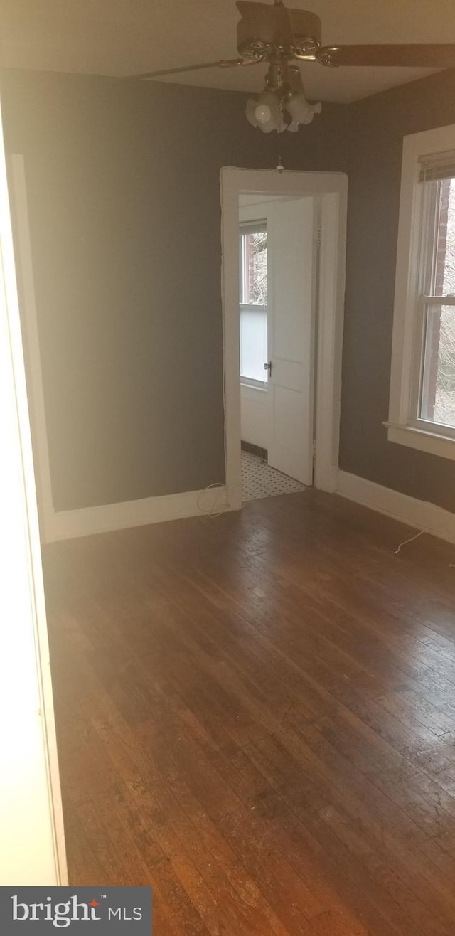 empty room featuring ceiling fan and hardwood / wood-style floors