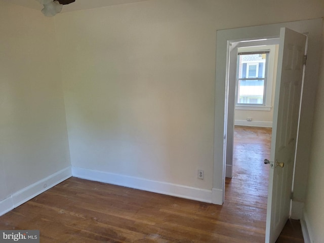 unfurnished room with dark hardwood / wood-style floors