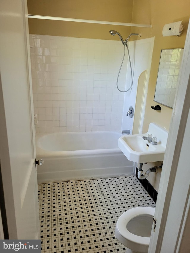 bathroom with washtub / shower combination and tile patterned flooring