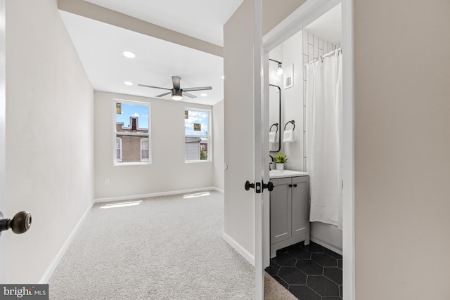 bathroom featuring ceiling fan and vanity