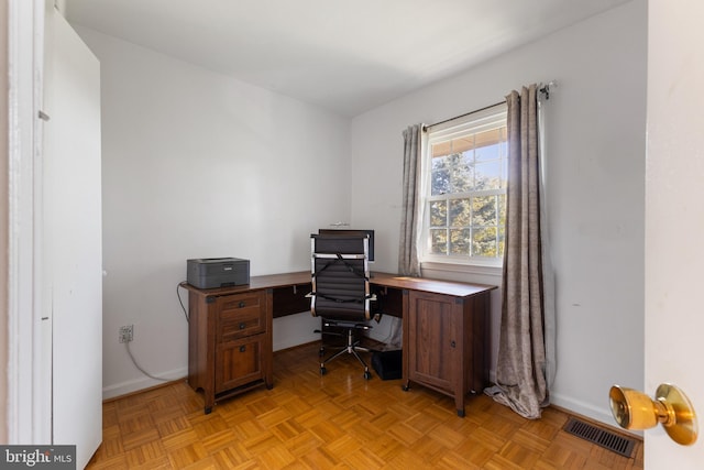 office space with light parquet flooring