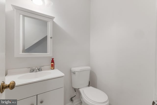 bathroom featuring toilet and vanity