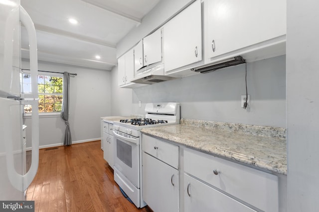 kitchen featuring hardwood / wood-style floors, white cabinets, and white appliances