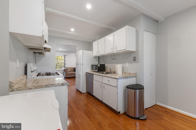 kitchen featuring sink, white cabinetry, stainless steel appliances, and light wood-type flooring