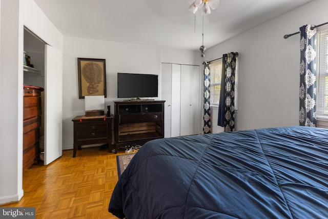 bedroom featuring ceiling fan and light parquet floors