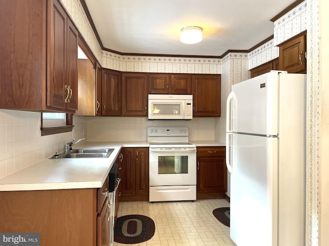 kitchen featuring sink, white appliances, and decorative backsplash