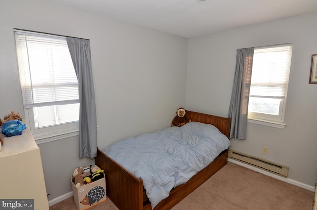 bedroom with baseboard heating, multiple windows, and carpet floors