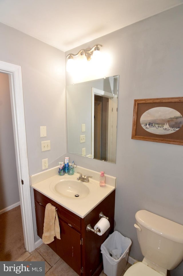 bathroom featuring toilet, tile patterned floors, and vanity