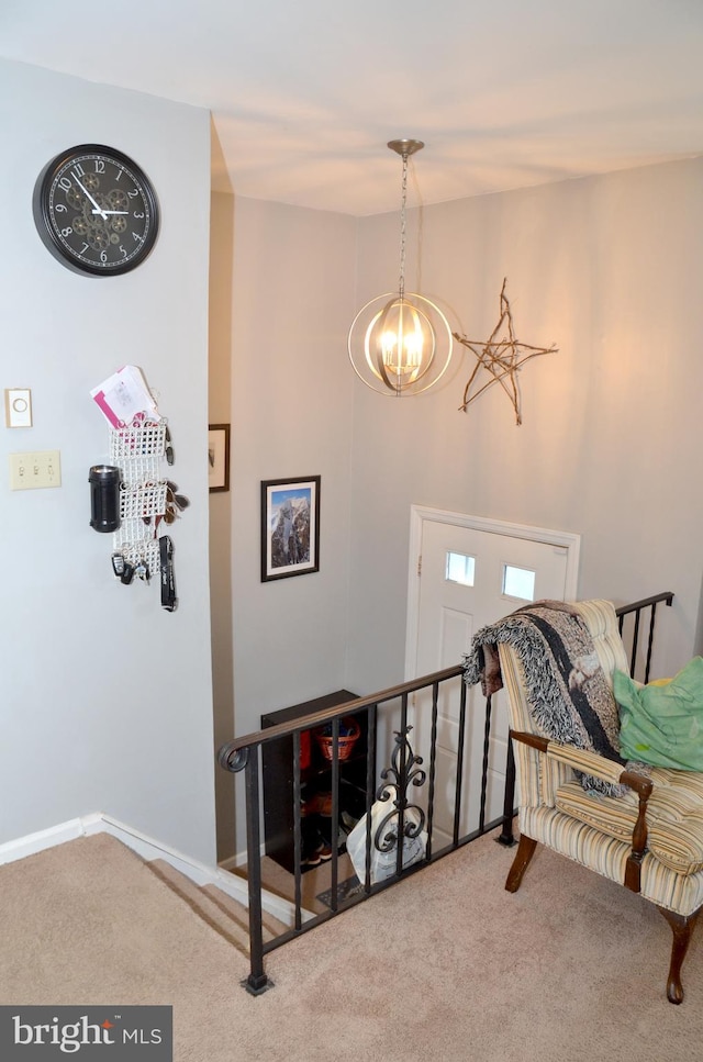 sitting room with a chandelier and carpet flooring