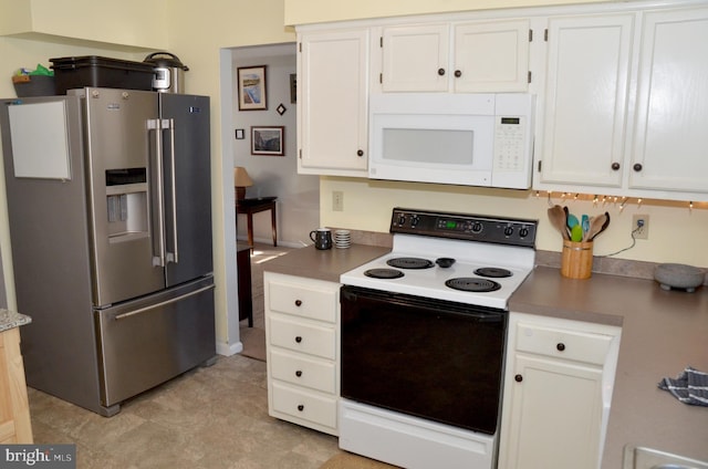 kitchen with white cabinets, high end refrigerator, and electric stove