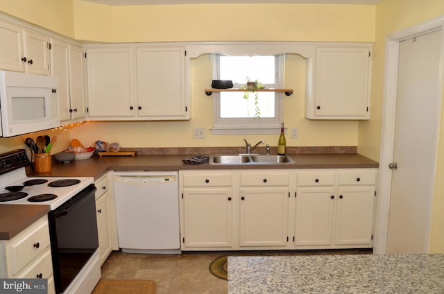 kitchen with sink, white appliances, and white cabinets