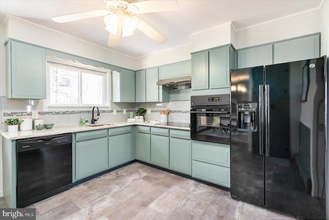 kitchen with black appliances, a sink, light countertops, and decorative backsplash