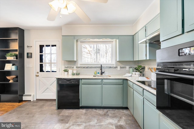 kitchen with a baseboard radiator, decorative backsplash, a sink, under cabinet range hood, and black appliances