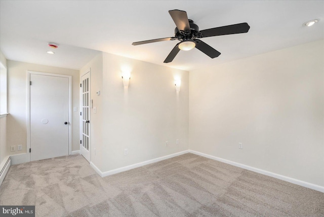 carpeted empty room featuring baseboards