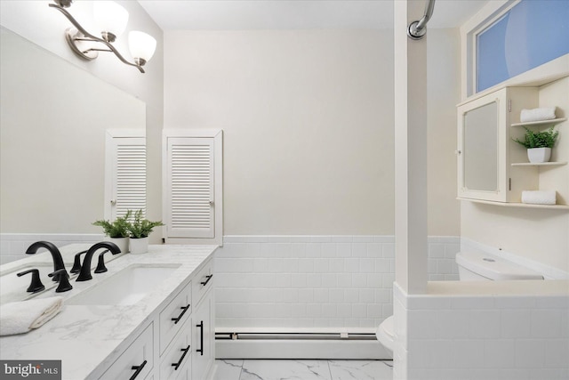 bathroom featuring a baseboard heating unit, marble finish floor, vanity, and toilet