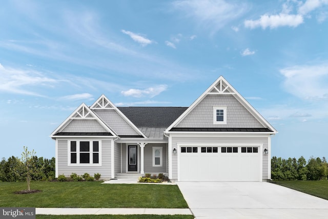 craftsman inspired home featuring a front yard and a garage