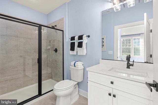 bathroom featuring toilet, tile patterned floors, walk in shower, and vanity