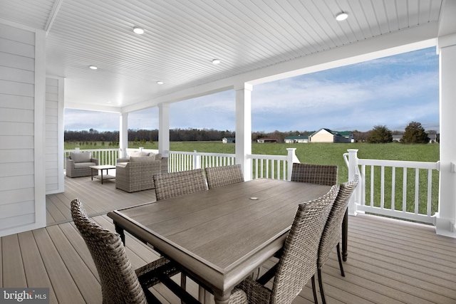 deck featuring outdoor lounge area and a yard