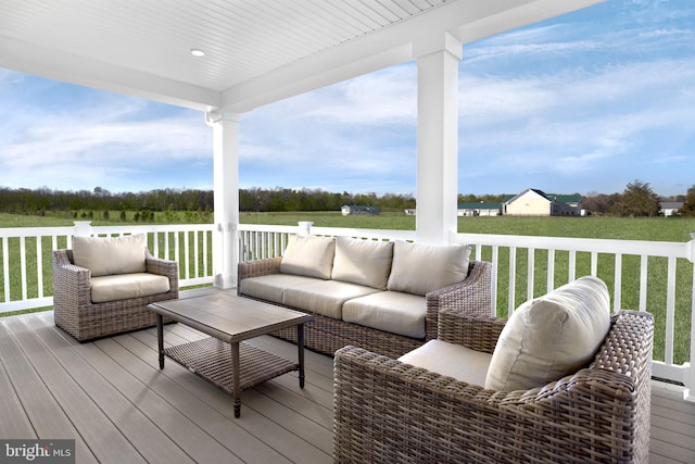 wooden deck featuring a yard and an outdoor hangout area