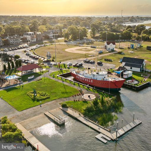 aerial view at dusk featuring a water view