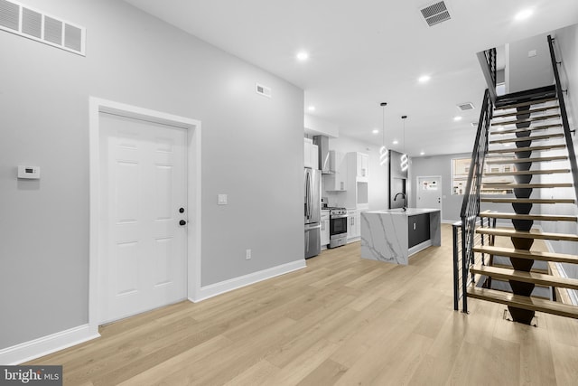 interior space with sink and light wood-type flooring