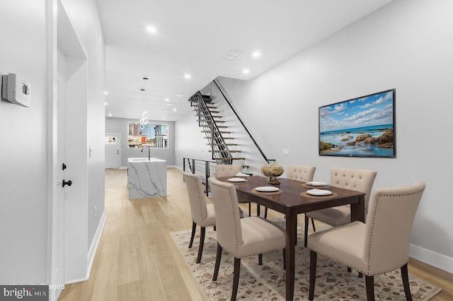 dining space featuring light hardwood / wood-style floors and sink