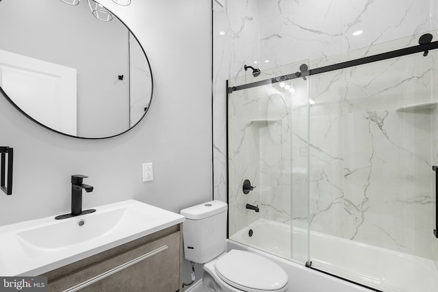 full bathroom featuring shower / bath combination with glass door, vanity, and toilet