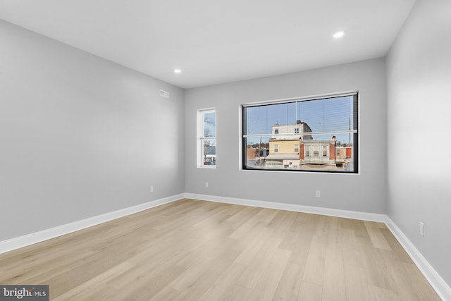 empty room with light hardwood / wood-style flooring