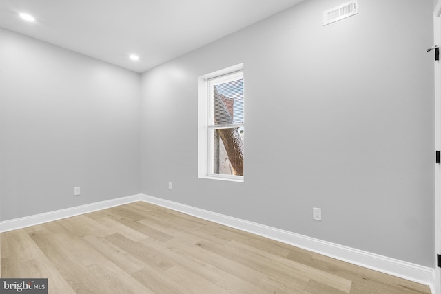 unfurnished room with light wood-type flooring