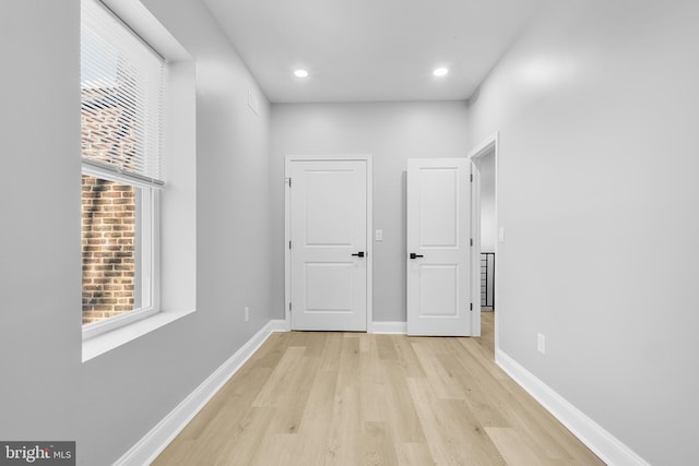 corridor with light hardwood / wood-style flooring